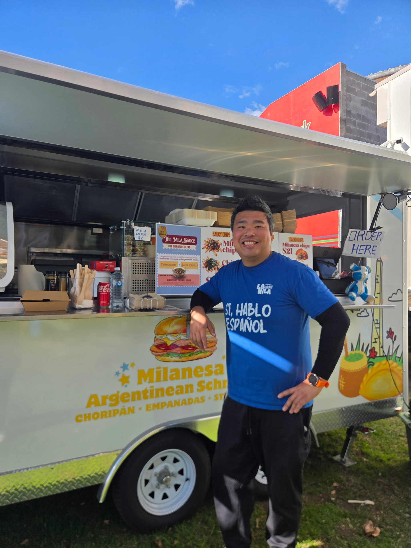 Alejandro Chen standing with the La Mila food trailer