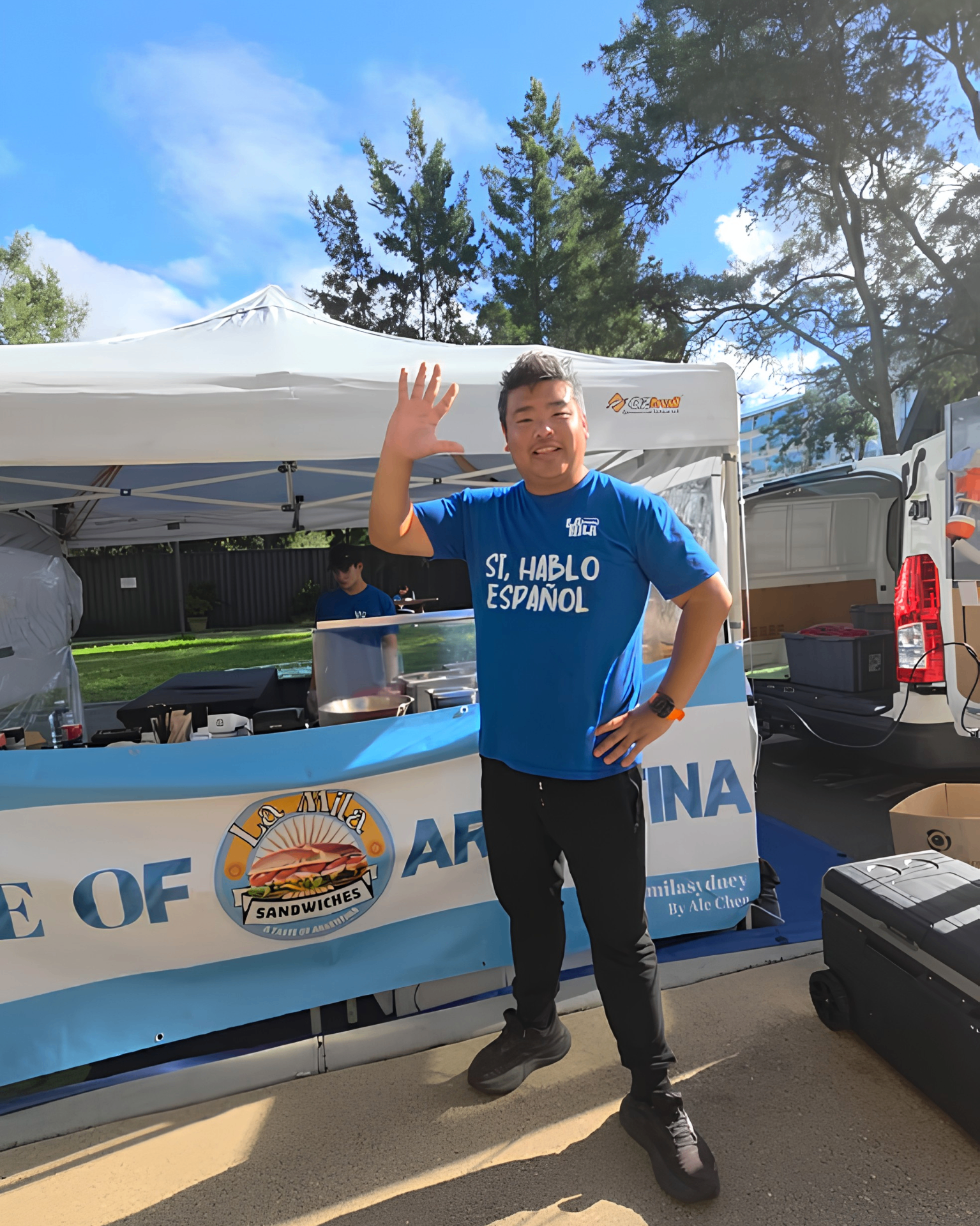 Alejandro Chen, founder of La Mila, standing with the professional marquee